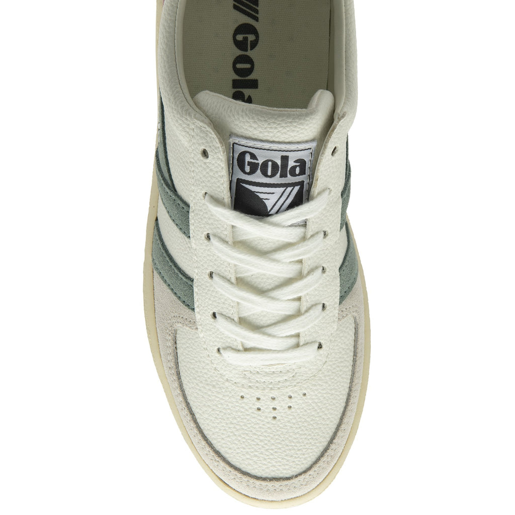 The top-down view of a cream Gola sneaker with green stripes and white laces.