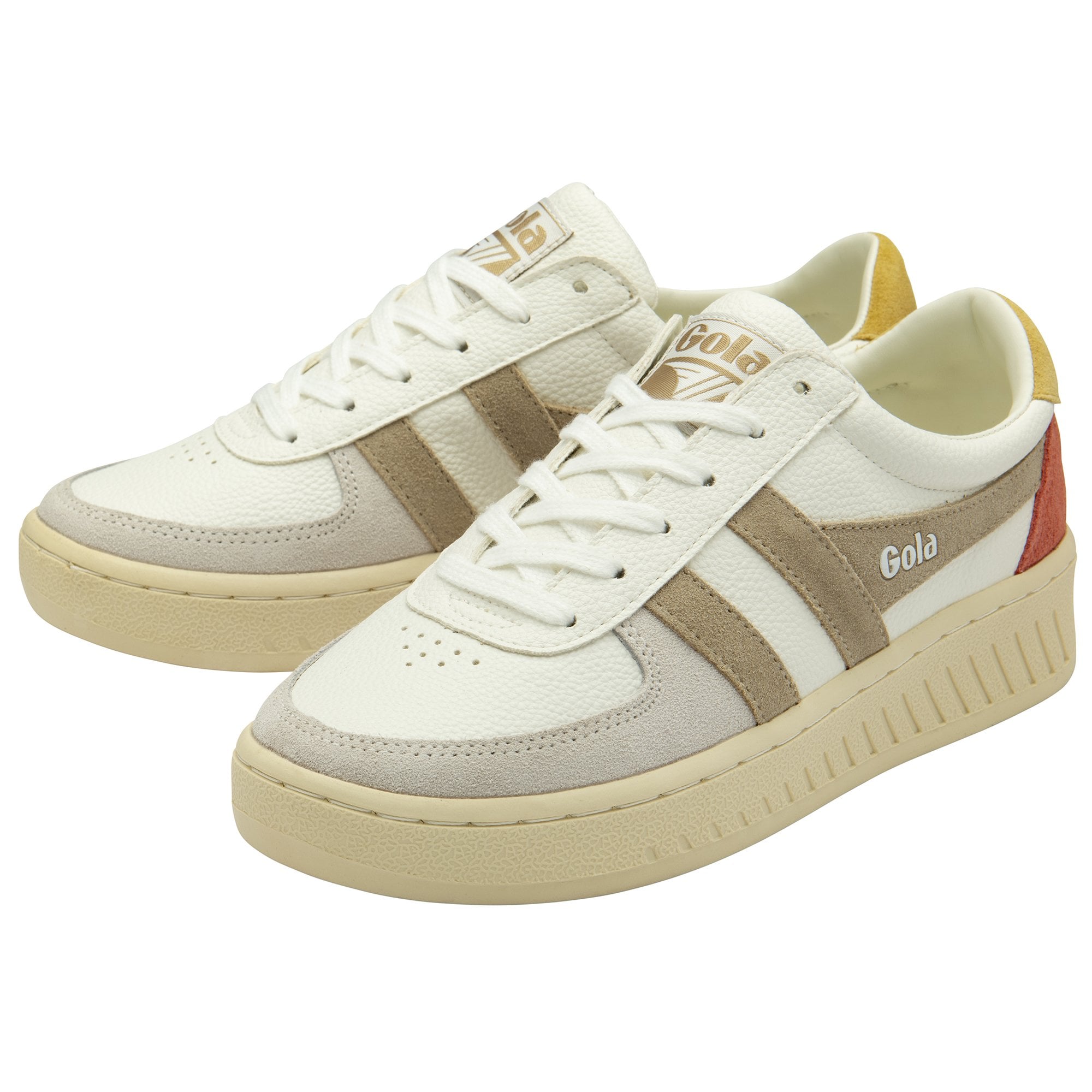 A pair of white Gola sneakers with beige stripes and red and yellow accents.
