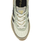 The top-down view of a single white Gola sneaker with black stripes and laces.