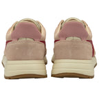 The back of two pale pink sneakers, showing the heels and part of the soles.