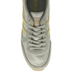 Top-down view of a silver Gola Orchid sneaker with yellow stripes and grey laces.