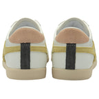 The back of two white Gola sneakers, showing pink heel tabs and dark gray accents.