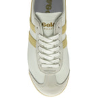 A close-up top view of the front of a white Gola sneaker with gold stripes and white laces.