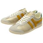 A pair of women's trainers in gold with yellow stripes and green heel collars.