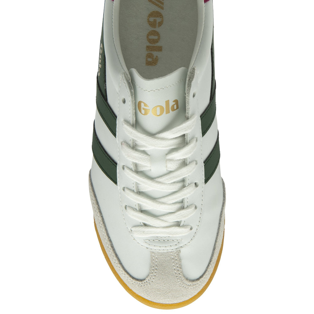 An overhead view of a white Gola sneaker with green stripes and white laces.