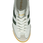 An overhead view of a white Gola sneaker with green stripes and white laces.