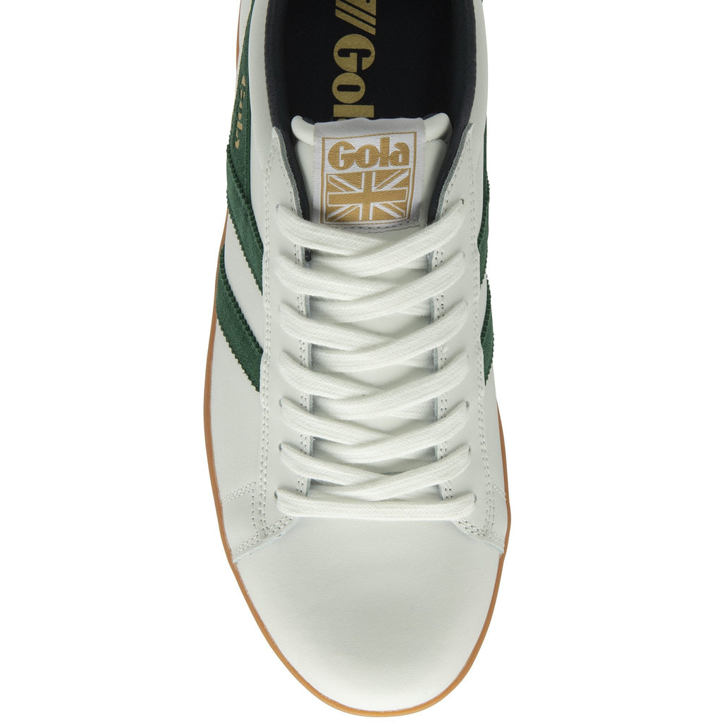 A top-down view of a white Gola trainer with green stripes.