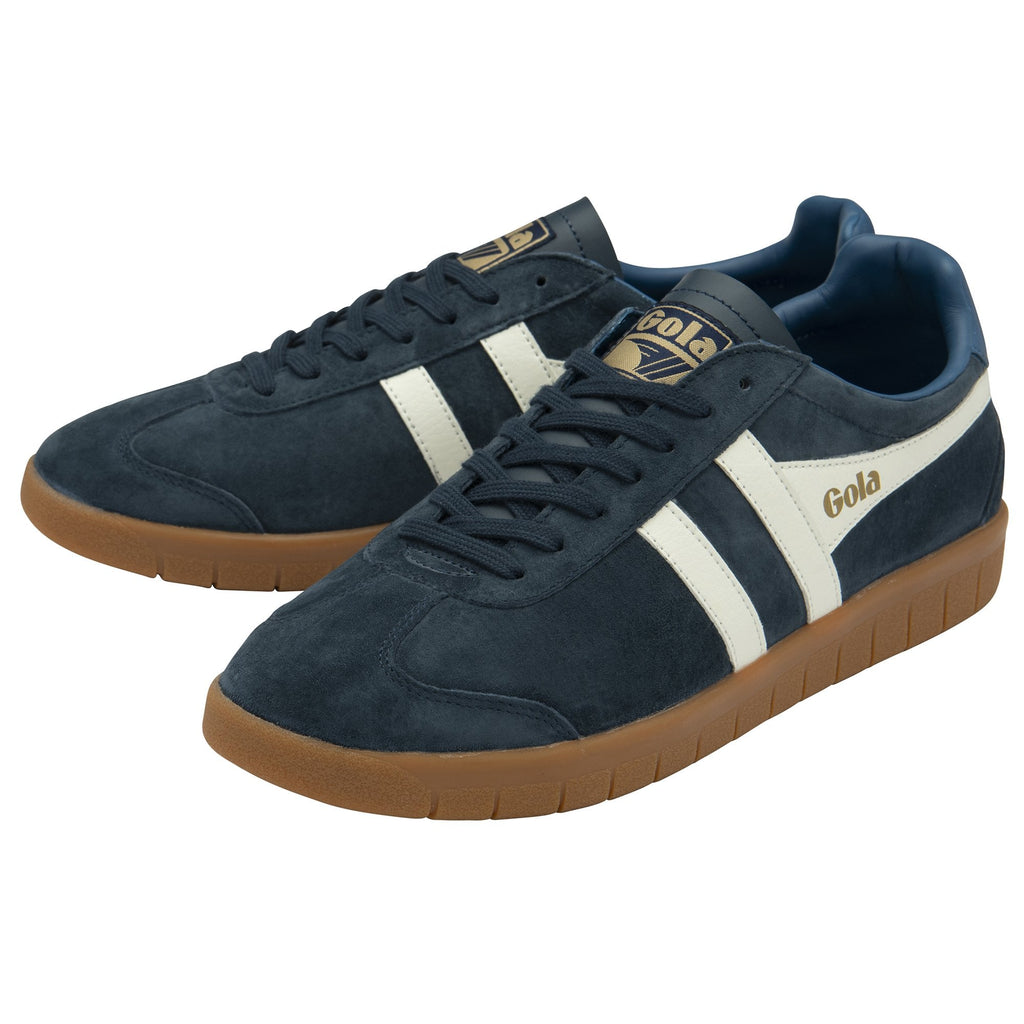 A pair of navy Gola trainers with white stripes and light blue heels.