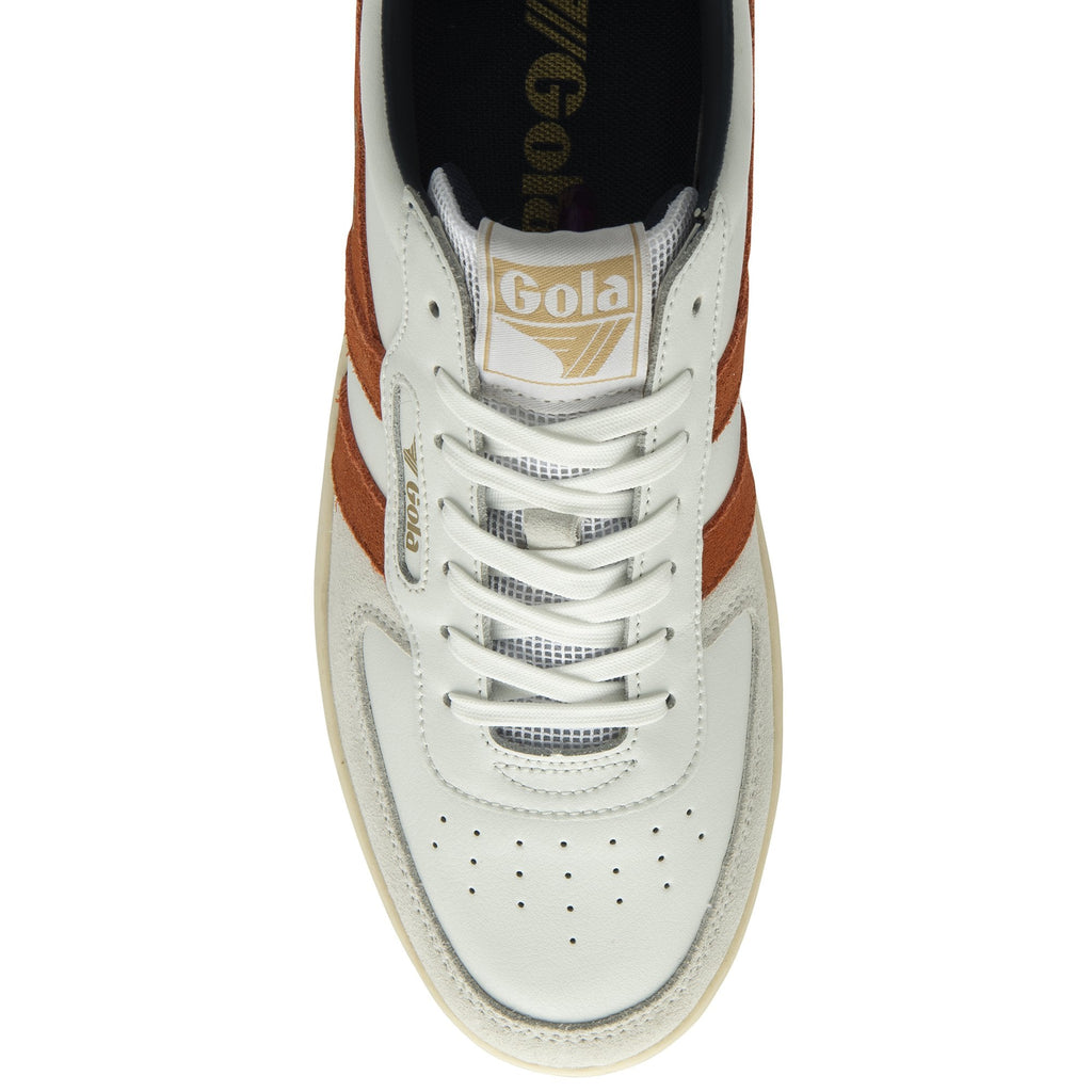 The top-down view of an off-white Gola sneaker with burnt orange stripes.
