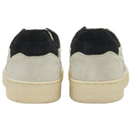 The back view of a pair of off-white Gola sneakers with black heel tabs.