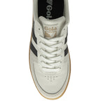 A white Gola sneaker with black stripes and a tan sole, viewed from above.