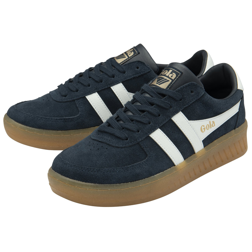 A pair of men's trainers with navy blue suede uppers and white accents.