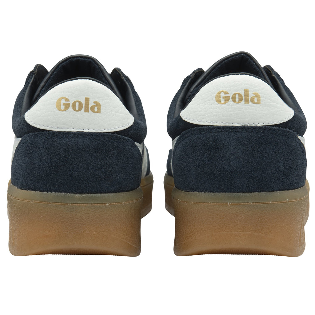Rear view of two men's trainers with navy blue suede and white accents.
