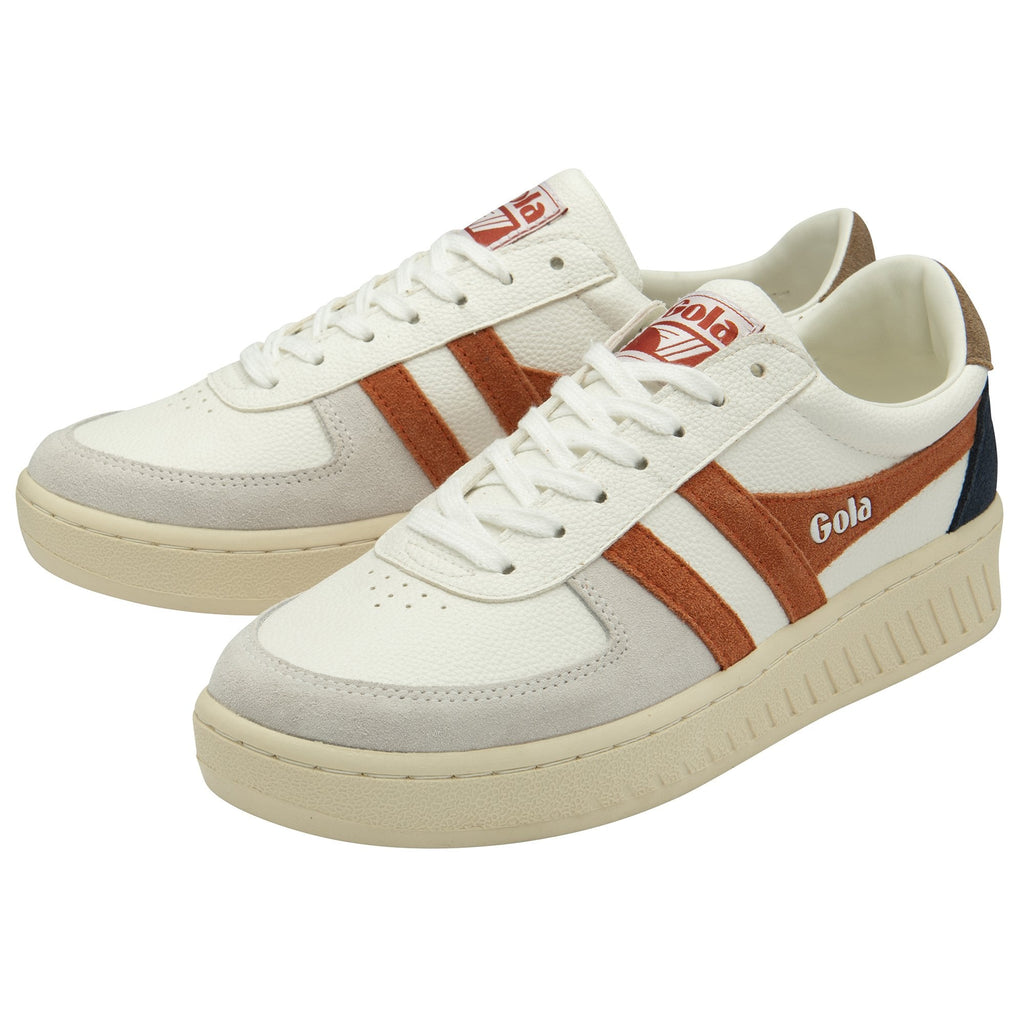 A pair of recycled men's trainers with white uppers and subtle orange accents.