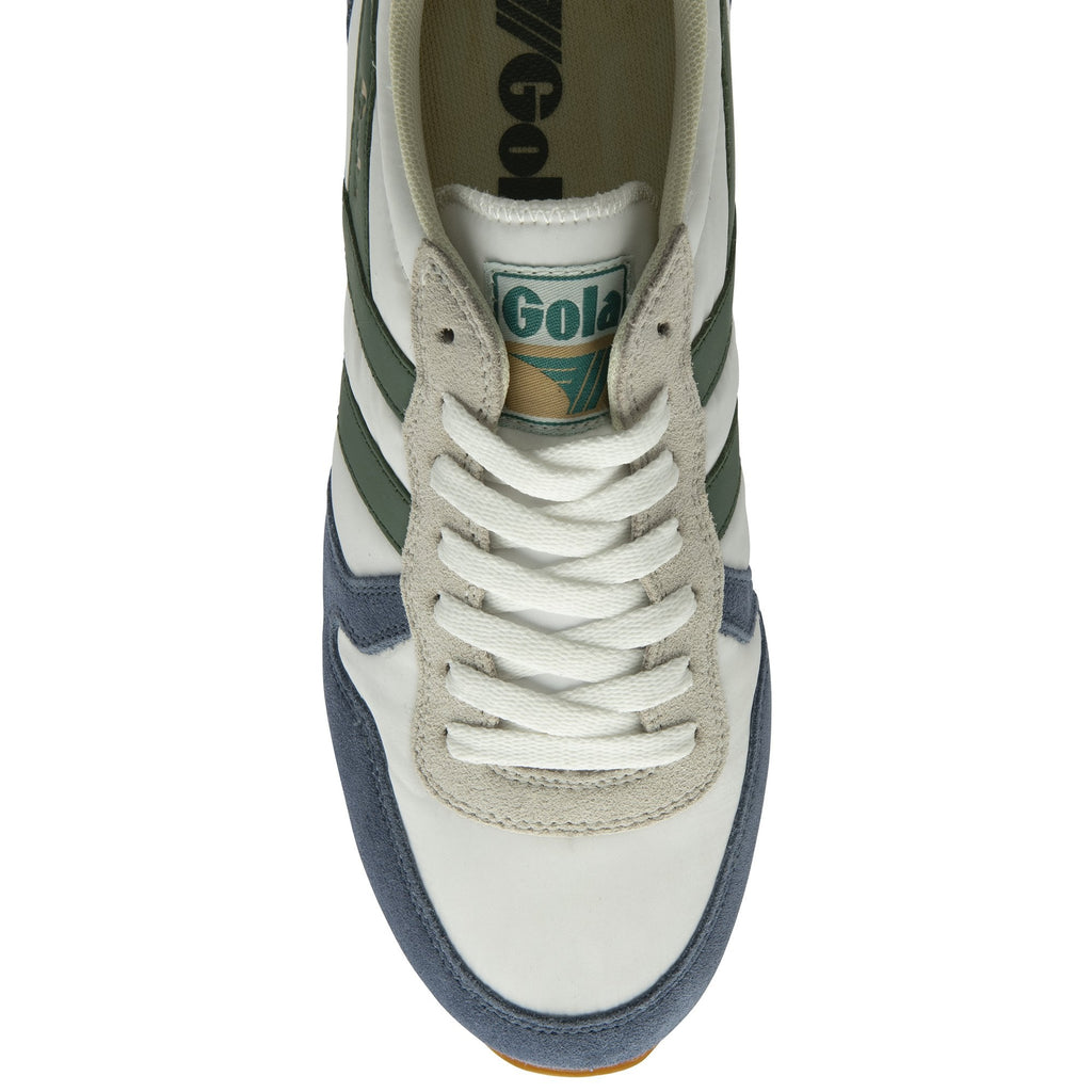 The top view of a white and blue Gola sneaker with green stripes and white laces.