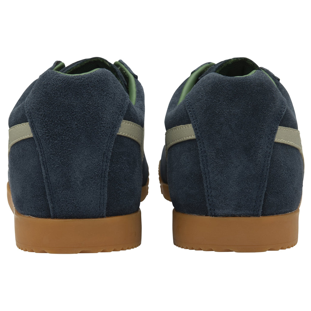 A pair of Gola Daytona trainers in navy blue with cream stripes from the back.