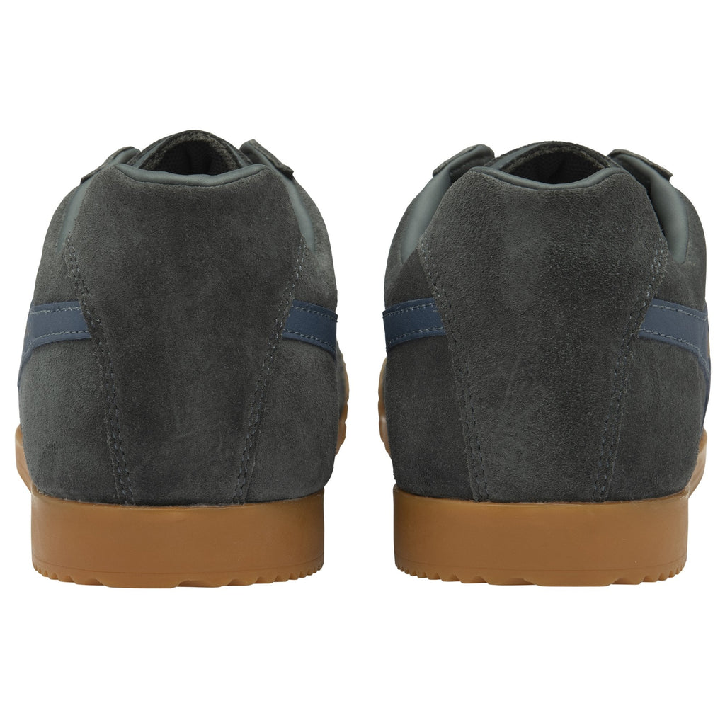 The back view of a pair of gray Gola sneakers with blue stripes and gum soles.