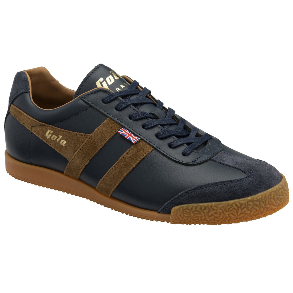 A single men's Gola Harrier trainer, navy leather with brown suede stripes, on a white background.