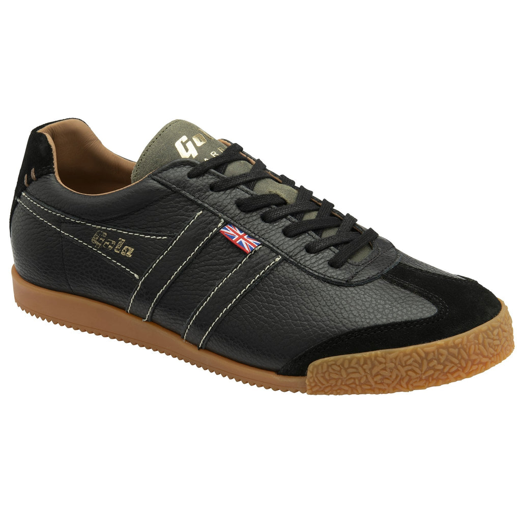 A single Gola low-top trainer in black with a gum sole, viewed from the left side.