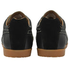 A pair of Gola low-top trainers in black with gum soles, viewed from the rear.