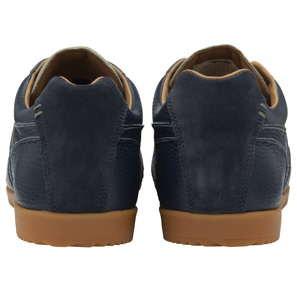 A rear view of a pair of Gola men's Harrier 72 trainers in navy with a light gum sole.