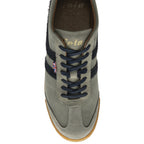 A top-down view of a light gray sneaker with dark blue stripes and laces.