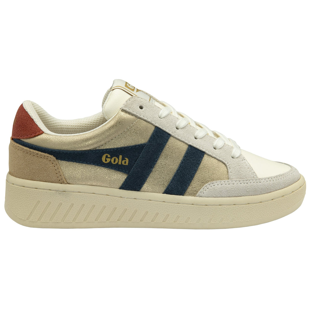 Side profile of a Gola shoe. It is white, cream, and beige with blue stripes and a reddish-brown heel.