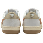 The back of two white and gold sneakers with white midsoles and brown outsoles.