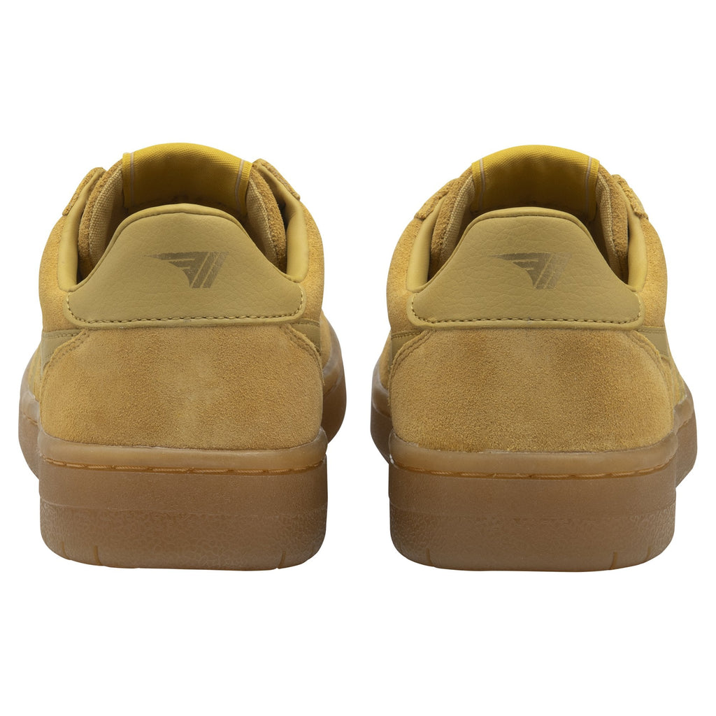 A pair of mustard yellow Gola trainers with gum soles, viewed from the back.