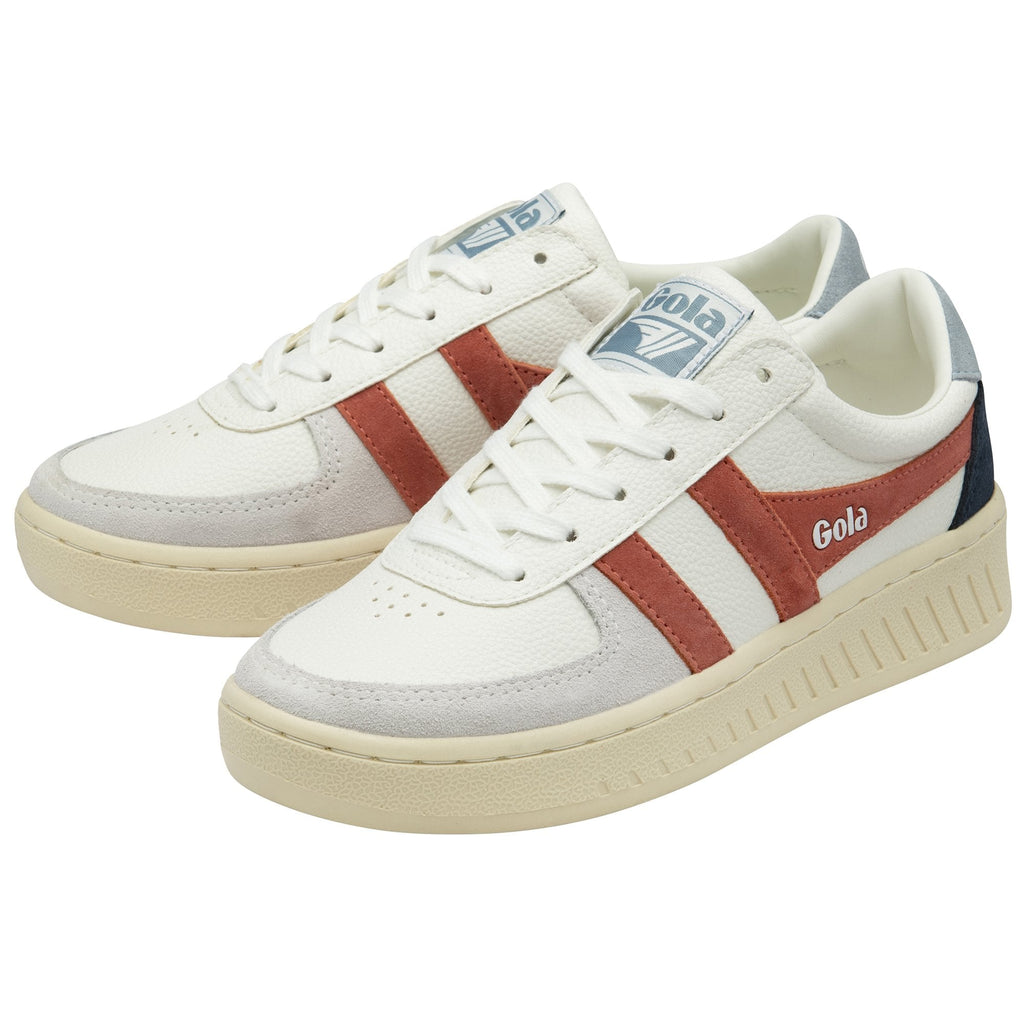 A pair of white Gola sneakers with rust-colored stripes and blue and black accents.