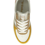 The top-down view of a white Gola sneaker with gold and brown accents on a white background.