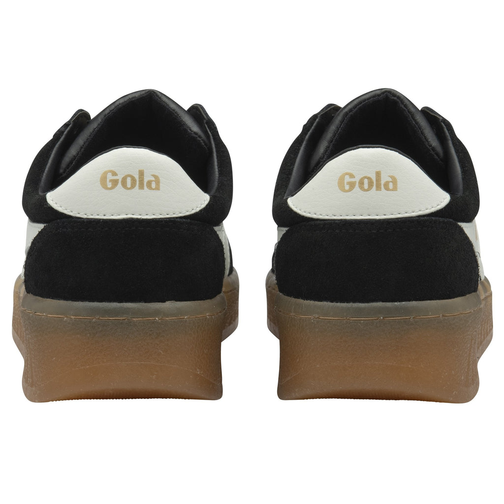 Rear view of a pair of black and white Gola low-top sneakers with gum soles.