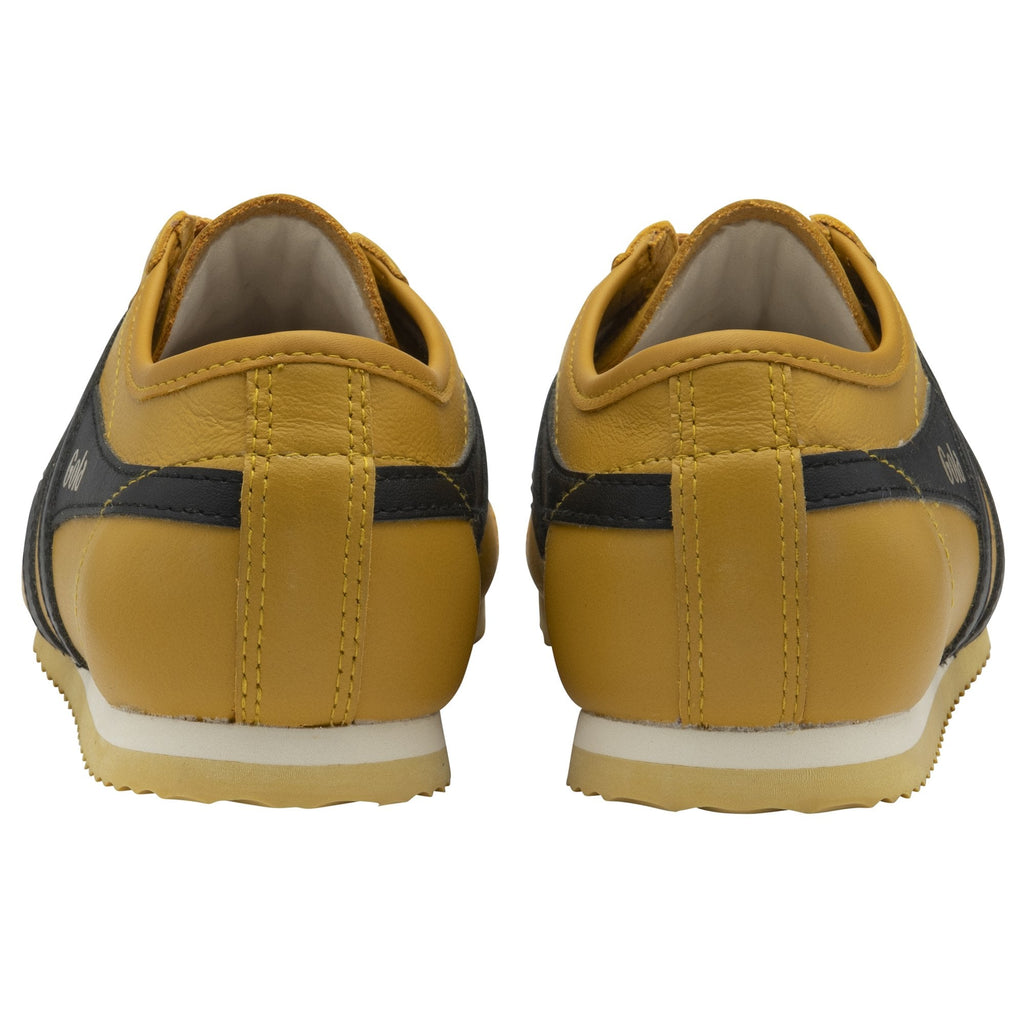 Rear view of a pair of Gola shoes in mustard color with black stripes. Available in size 9.