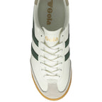 An overhead view of a Gola Elan trainer in off-white, green, and gold with a gum sole.