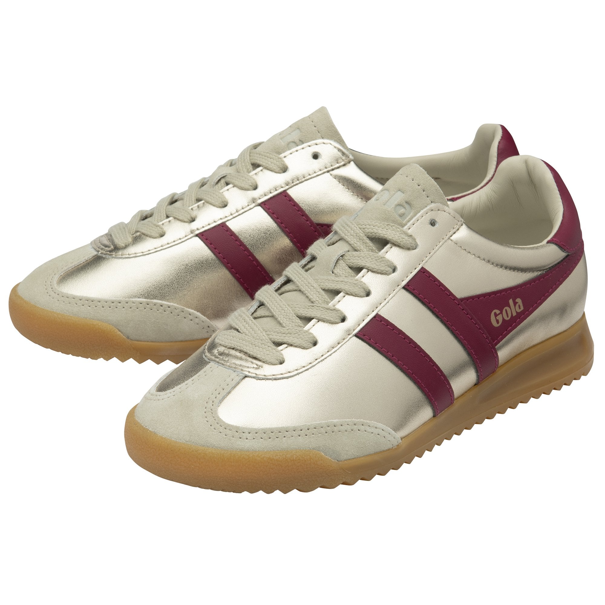 A pair of golden Gola sneakers with burgundy stripes and heel tabs.