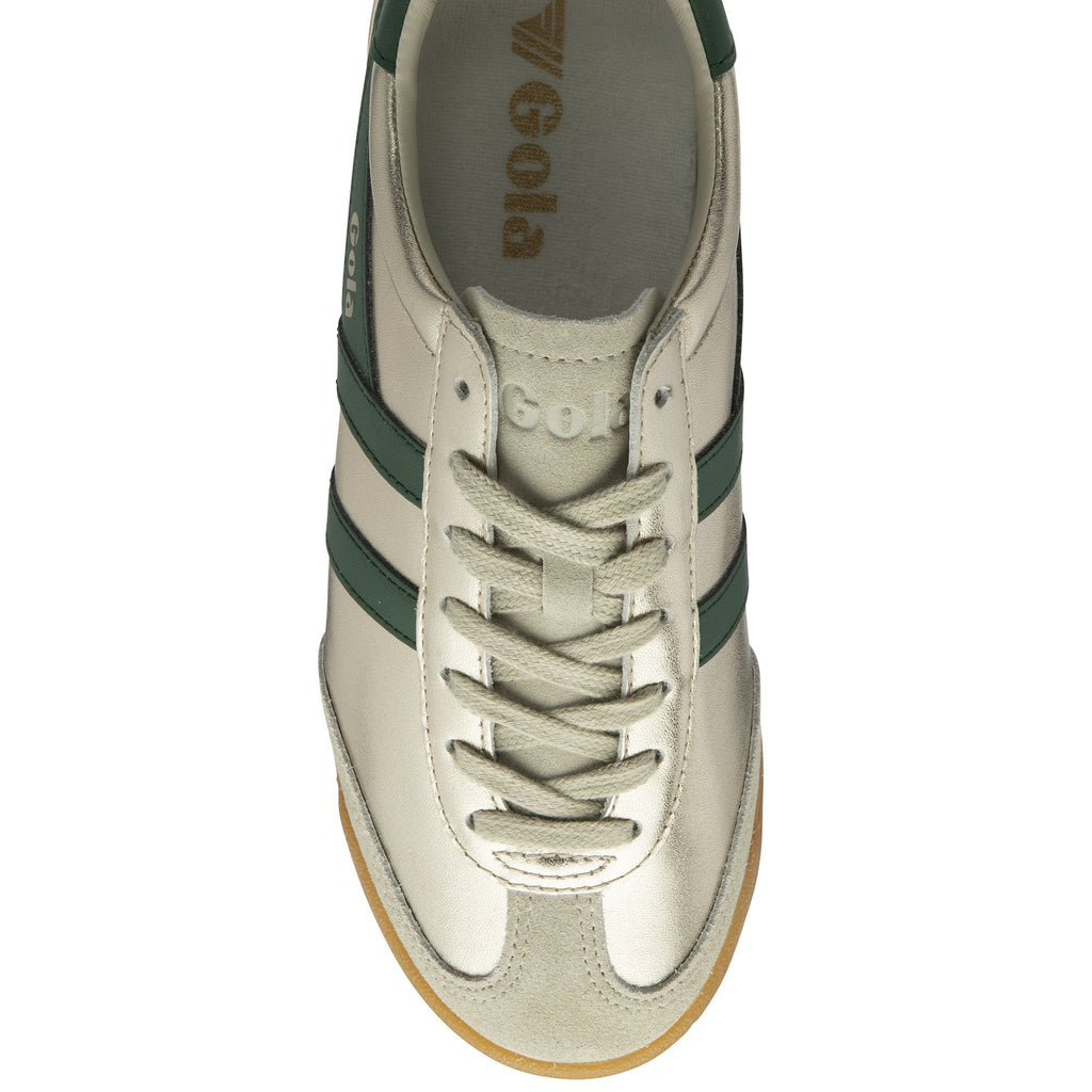 Top-down view of a single gold Gola sneaker with green stripes and tan sole.