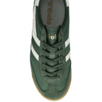 A top-down view of a green and white Gola trainer with a brown sole.
