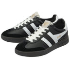 A pair of black and white Gola trainers with cream laces, angled on a white background.