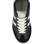 A top-down view of a single black and white Gola trainer with cream laces.