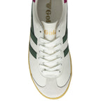 An overhead view of a white Gola sneaker with green stripes, white laces, and gum sole.