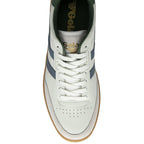 An overhead view of a white Gola sneaker with green and blue accents.