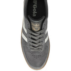 An overhead view of a single gray Gola sneaker with white stripes and a gum sole.