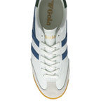 Top-down view of a white Gola sneaker with blue stripes and white laces.