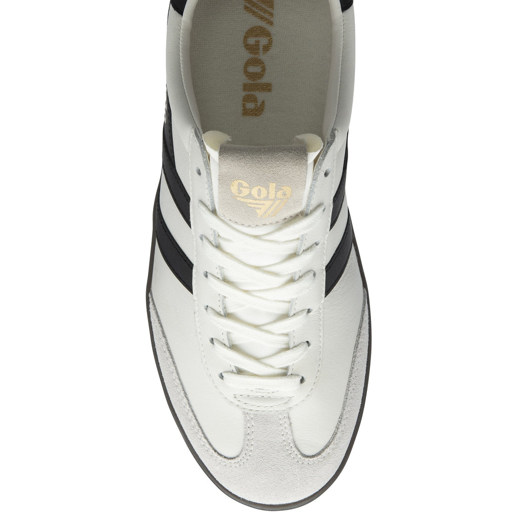 Top-down view of a white Gola sneaker with black stripes and white laces.