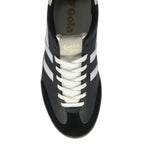 Top-down view of a black Gola men's trainer with white laces and stripes.