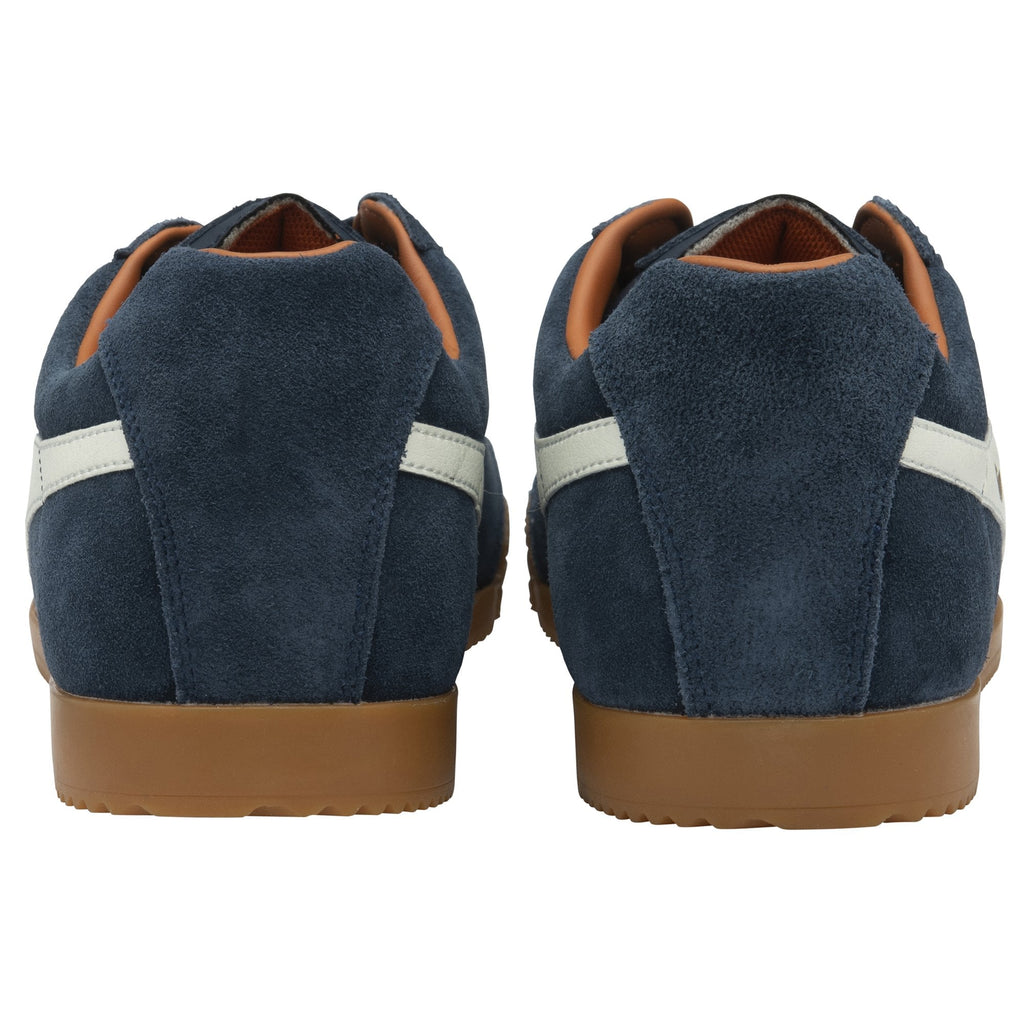 The back view of a pair of men's navy blue Gola Harrier suede trainers with white stripes.