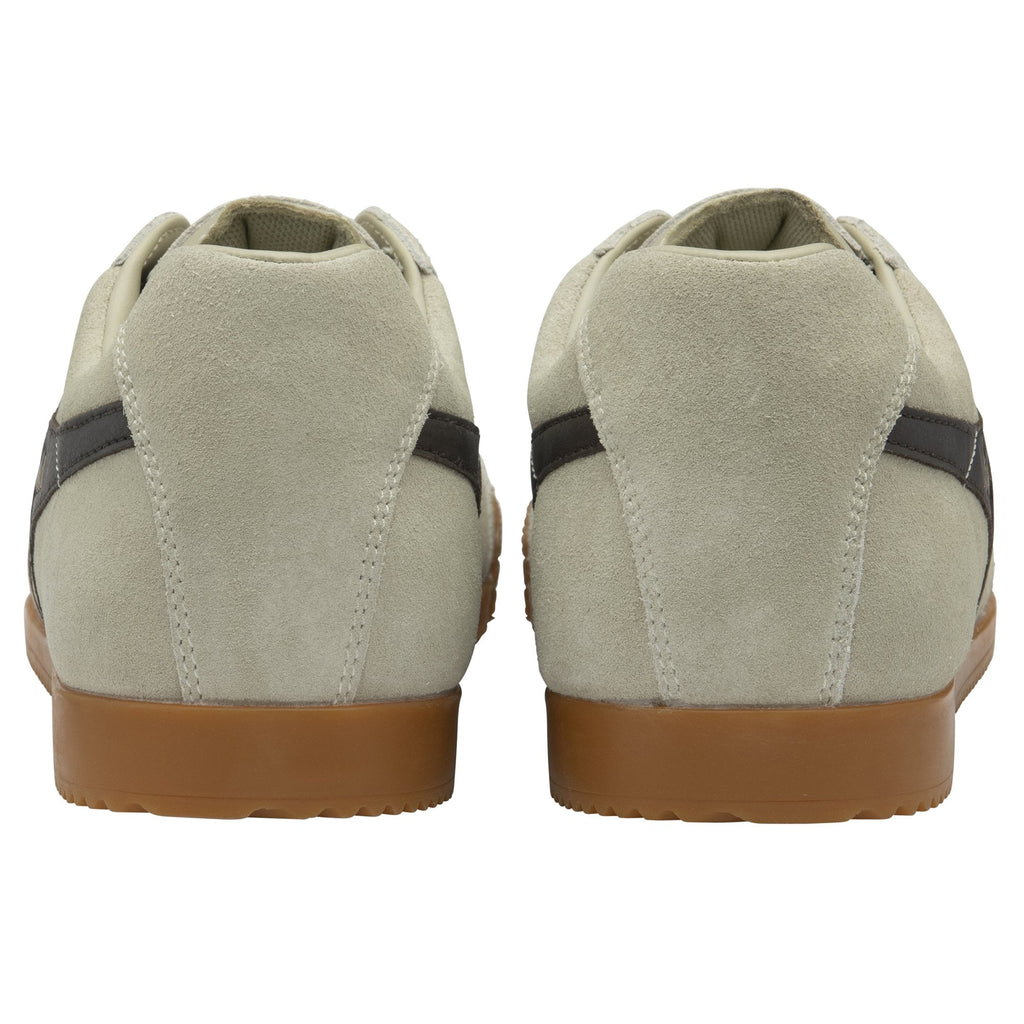 The back view of a pair of light grey Gola Harrier trainers with gum soles.