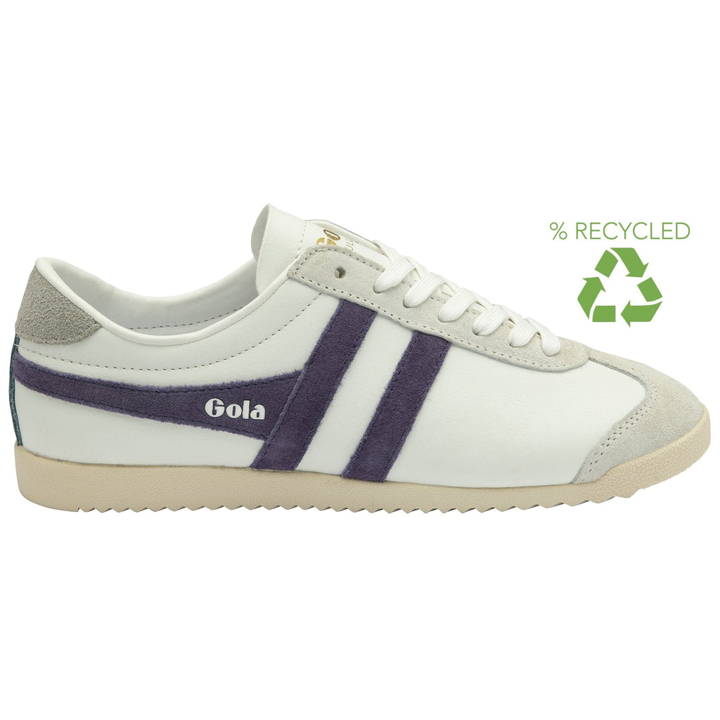 White Gola Bullet trainers with two purple stripes on the side, and an eco-friendly logo.
