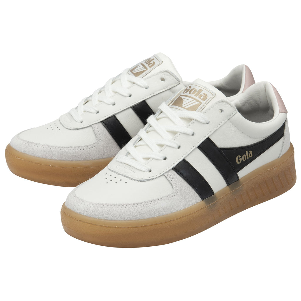 Pair of white Gola sneakers with black stripes and gum soles shown at an angle.