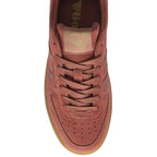 The top-down view of a single red-brown suede sneaker with a gum sole.